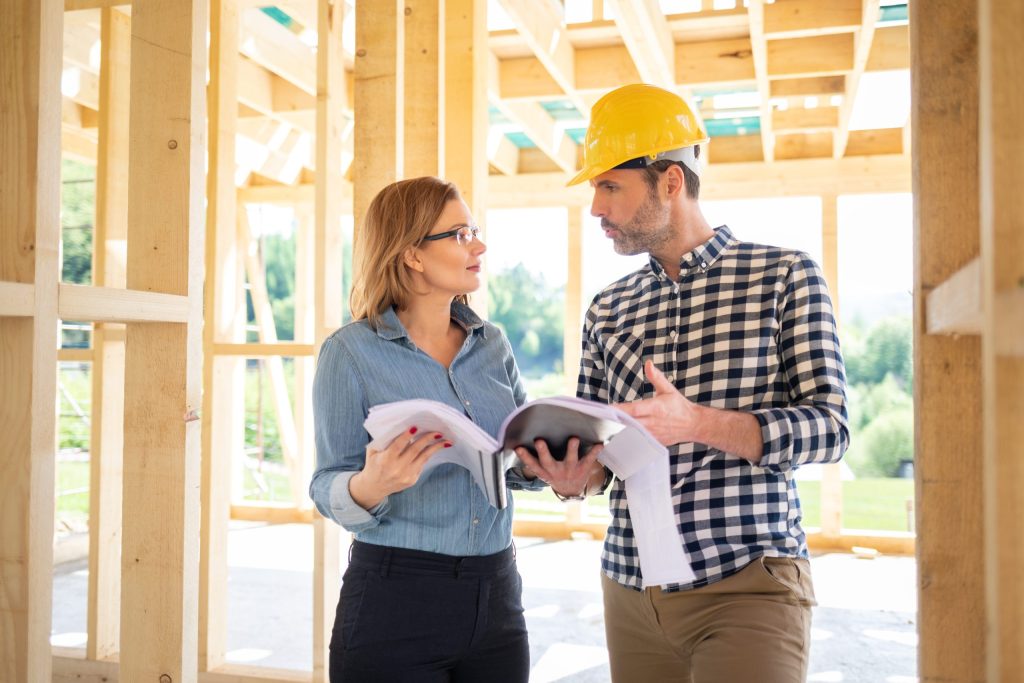 Construction project manager and other female team member discussing a plan